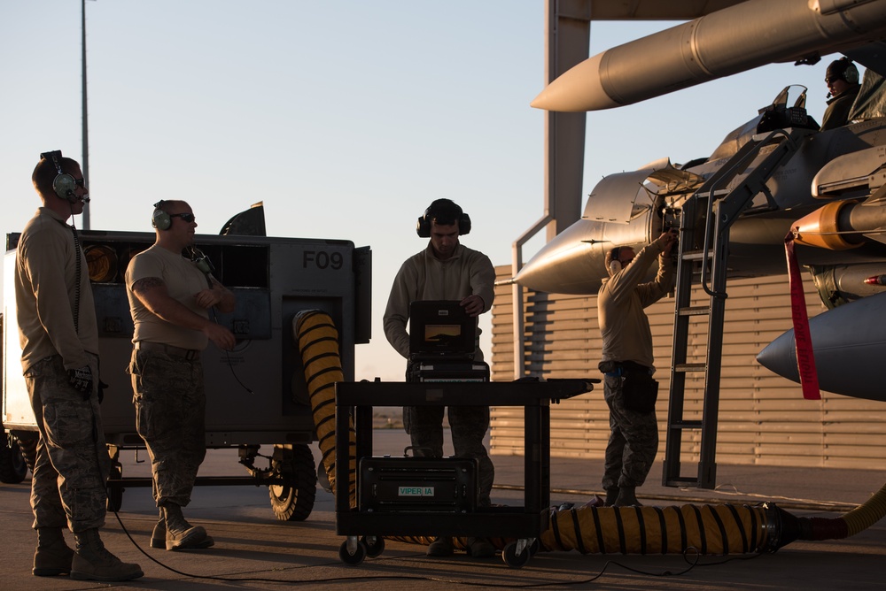 Prepping an F-16 for weapons load