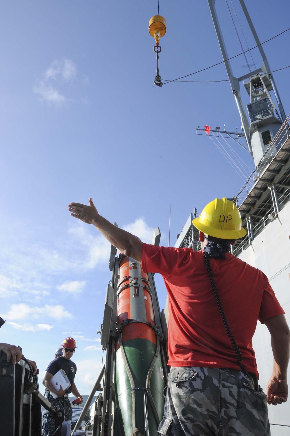 A Crane Signalman Assists during an Ordnance Transfer in Guam Feb. 10