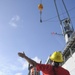 A Crane Signalman Assists during an Ordnance Transfer in Guam Feb. 10