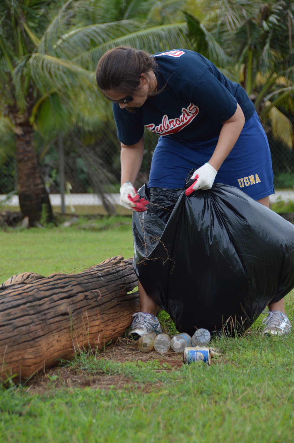 CSS-15 Sailor picks up trash at Eagles Field, Guam, Feb. 3