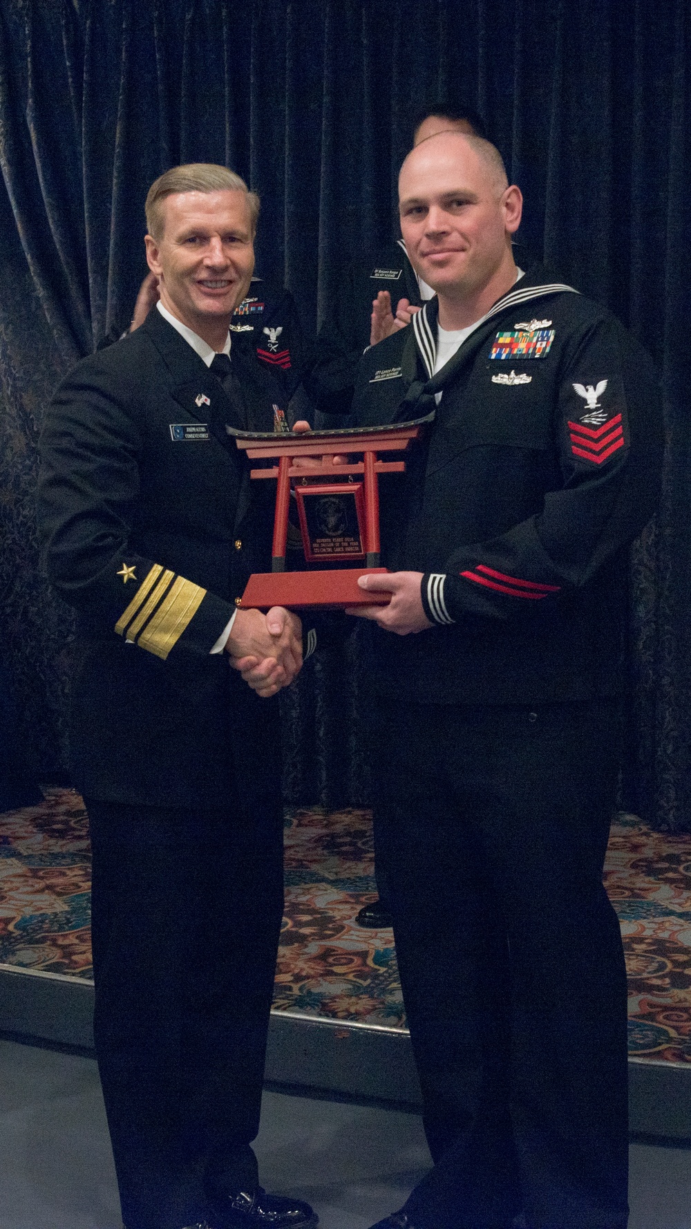 Vice Adm. Joseph Aucoin, Commander, U.S. 7th Fleet, awards the 7th Fleet FY-16 Sea Sailor of the Year