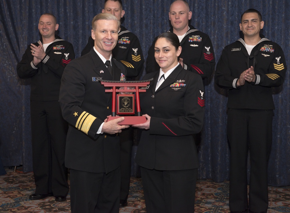 Vice Adm. Joseph Aucoin, Commander, U.S. 7th Fleet, awards the 7th Fleet FY-16 Shore Sailor of the Year