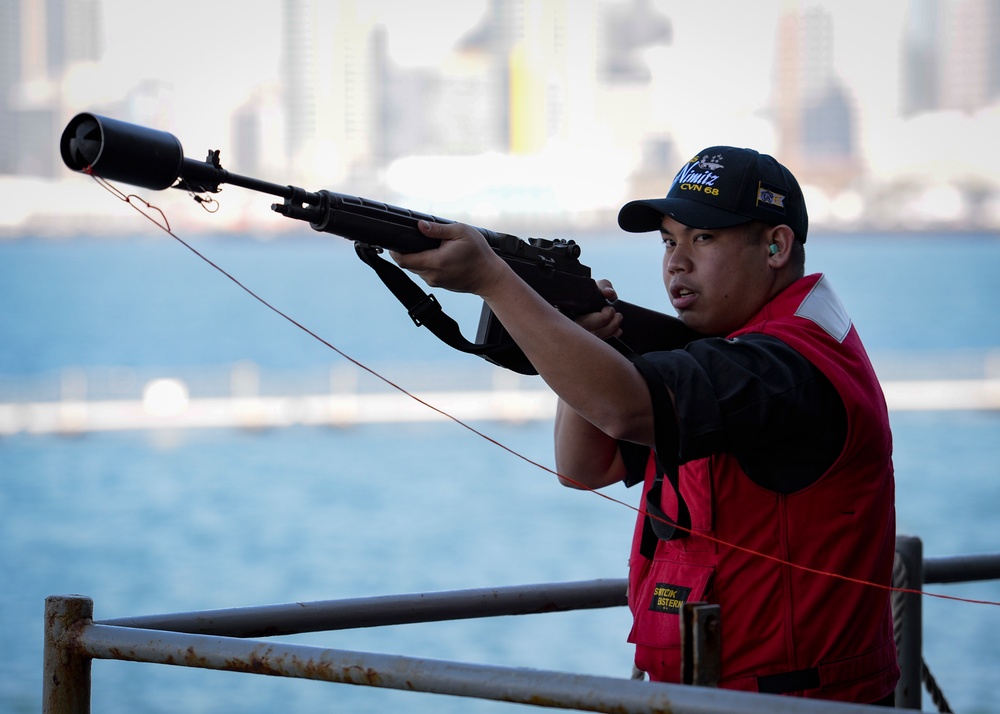 Nimitz Sailor prepares to fire shotline