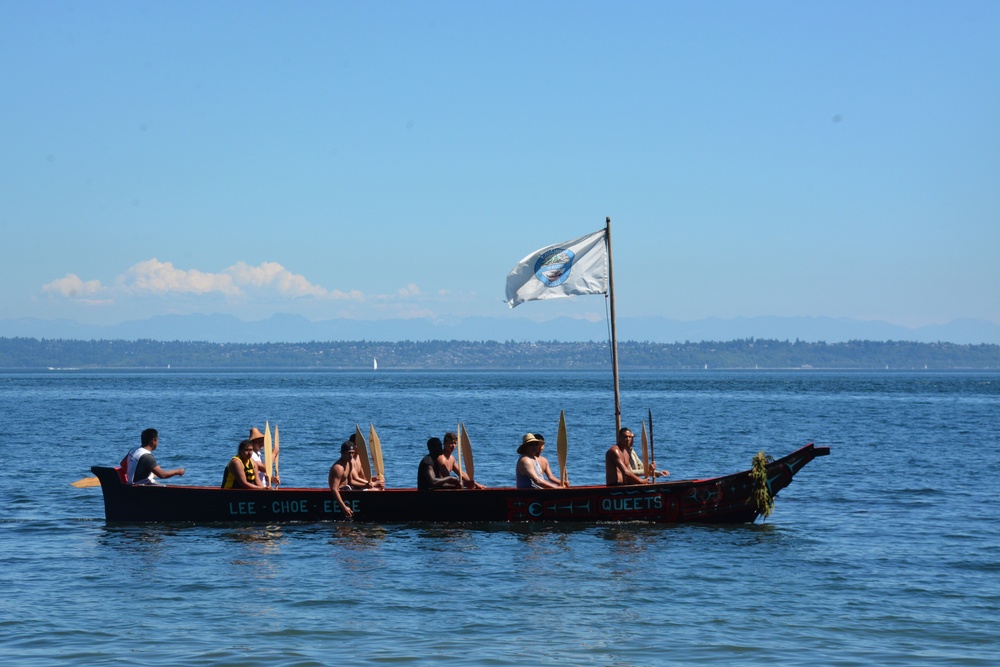 Sailors wait ashore to assist Squamish tribe with canoes