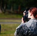 A soldier from Headquarters and Headquarters Company, 301st Maneuver Enhancement Brigade, checks her mask for a proper seal
