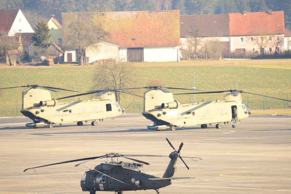 10th Combat Aviation Brigade Black Hawk and Chinook helicopters sit on the flight line at Katterbach Army Airfield in Ansbach, Bavaria, Germany