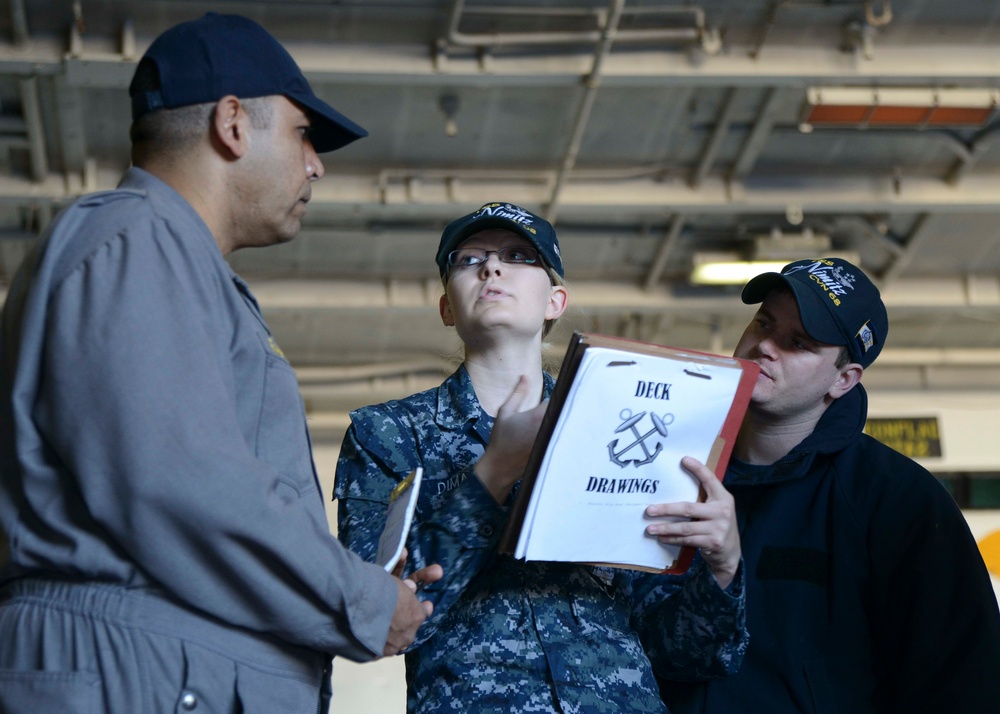 Inspector reviews deck drawings during demonstration