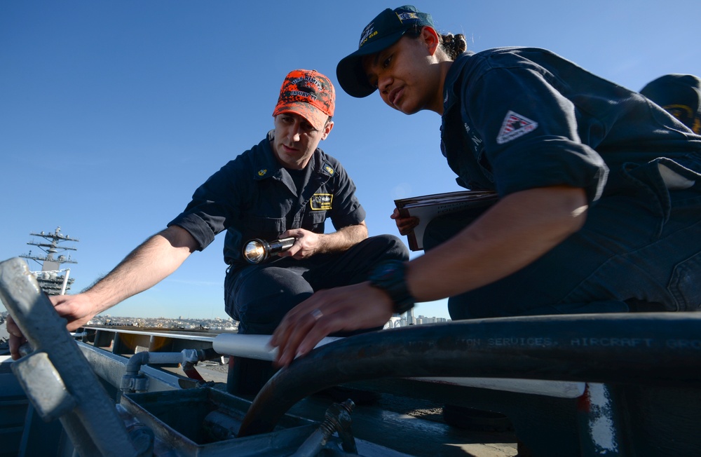 Sailors inspect equipment