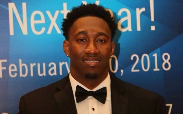 A man dressed in formal attire (black tuxedo with bow tie and red pocket square) is holding a crystal/glass award trophy at what appears to be an awards ceremony. The backdrop indicates the event took place on February 2018. The award trophy is partially readable and references 'Engineer of the Year Awards 2017'.