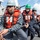 170212-N-HI376-053 A group of U.S. Navy sailors in uniform are performing a line-handling evolution on the deck of a naval warship, pulling a thick mooring rope in coordinated effort. The sailors are wearing standard Navy Working Uniform (NWU) digital camouflage, orange life vests, and hard hats in varying colors indicating different roles or departments. The scene appears to be a mooring or underway replenishment operation conducted aboard what appears to be a U.S. Navy destroyer or cruiser.
