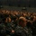 170214-N-XF155-010 A large auditorium filled with hundreds of military personnel in Navy Working Uniform (NWU) digital camouflage pattern seated in rows of theater-style chairs. The gathering appears to be a formal all-hands meeting, briefing, or command presentation. The venue is a dedicated military auditorium with overhead speakers and controlled lighting.