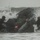 In the CRRC of Time: U.S. Marines and Japanese Soldiers conduct Recon Drills at Exercise Iron Fist A group of military personnel in full tactical gear are navigating a rigid inflatable boat (RIB) through heavy surf conditions. The boat appears to be capsizing or being overwhelmed by a large breaking wave during what appears to be a maritime training exercise. The personnel are wearing helmets and combat equipment consistent with special operations or amphibious assault training.