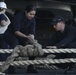 Sailors tie stopper onto mooring line