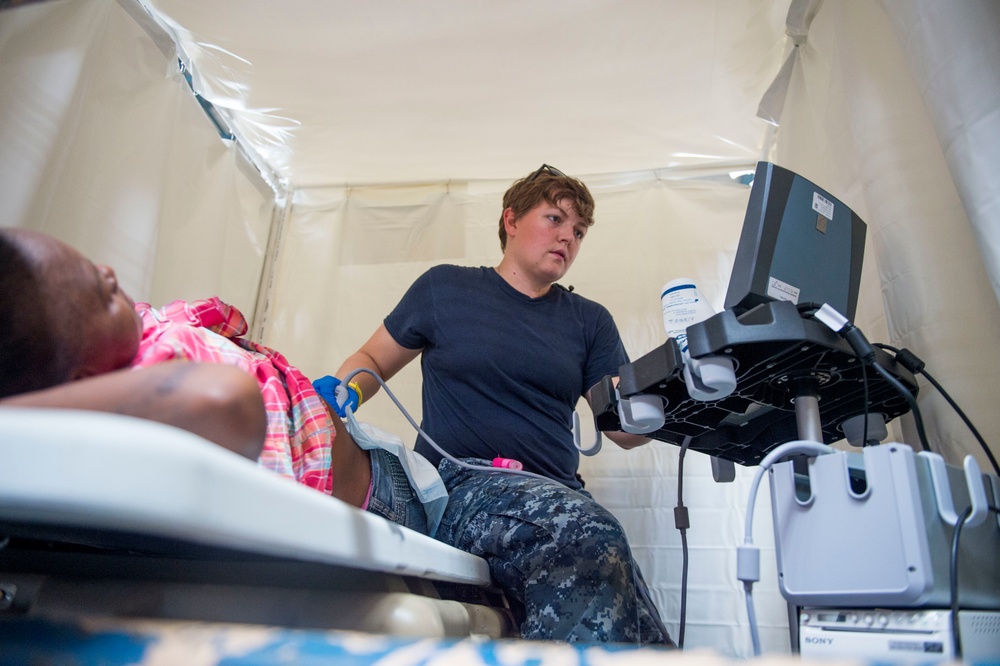Hospital Corpsman 2nd Class Jessica Poe performs an ultrasound on a host nation patient at the Continuing Promise 2017 (CP-17) medical site