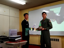 Lt.j.g. Andrew Bagnas exchanges gifts with a member of the Japanese Maritime Self Defense Force (JMSDF) during an interoperability exercise