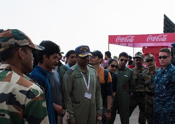 Lt.j.g. Ben Porter shows off Patrol Squadron Ten (VP-10) Red Lancer merchandise at Aero India 2017