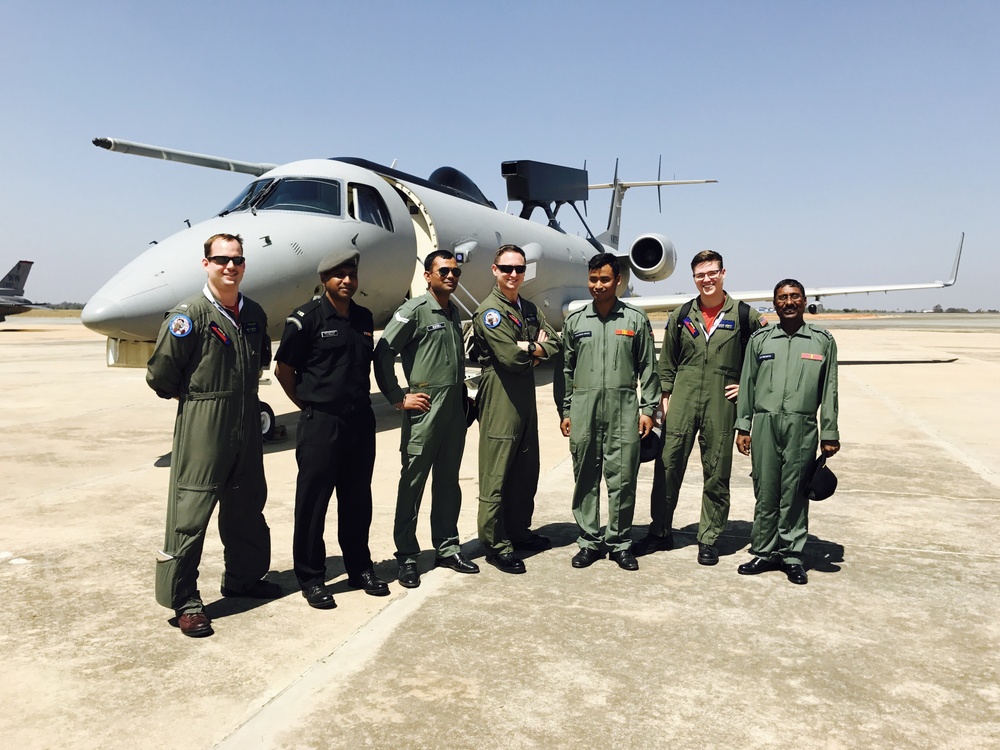 Patrol Squadron Ten (VP-10) Red Lancers pose with members of the Indian Air Force in front of a Defense Research and Development Organization (DRDO) Airborne Early Warning and Control System (AEWACS) at Aero India 2017