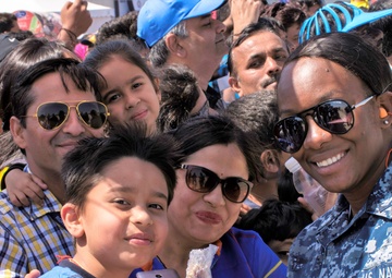 Aviation Structural Mechanic 2nd Class JodiAnn Taylor stops to take a picture with a local family at Aero India 2017