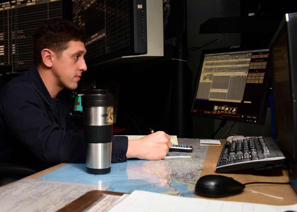 Sailor works as plotter on USS Nimitz