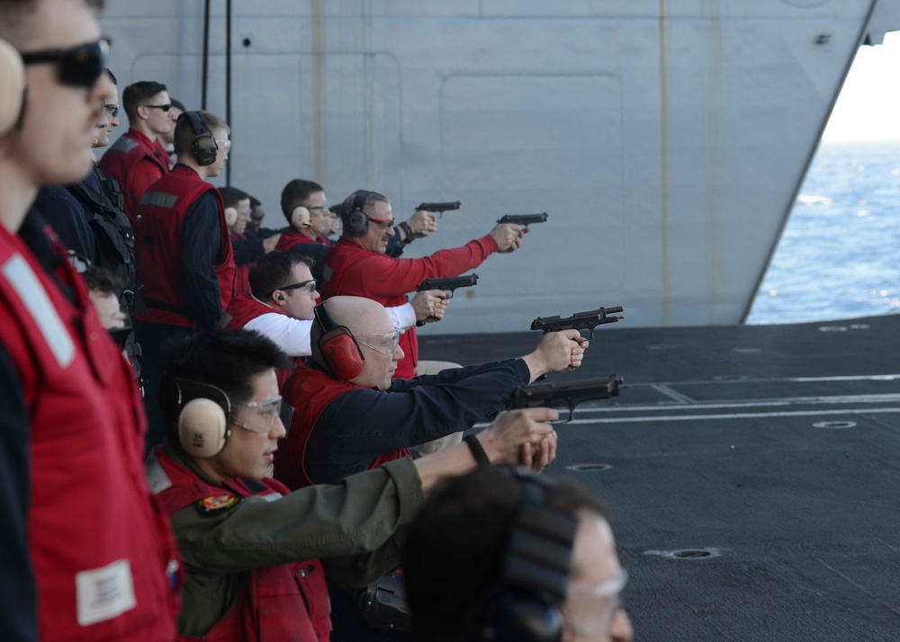 Officers participate in small-arms qualifications