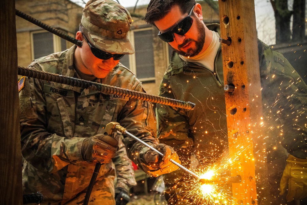 Paratrooper cuts steel rebar with the Silent Entry Torch System