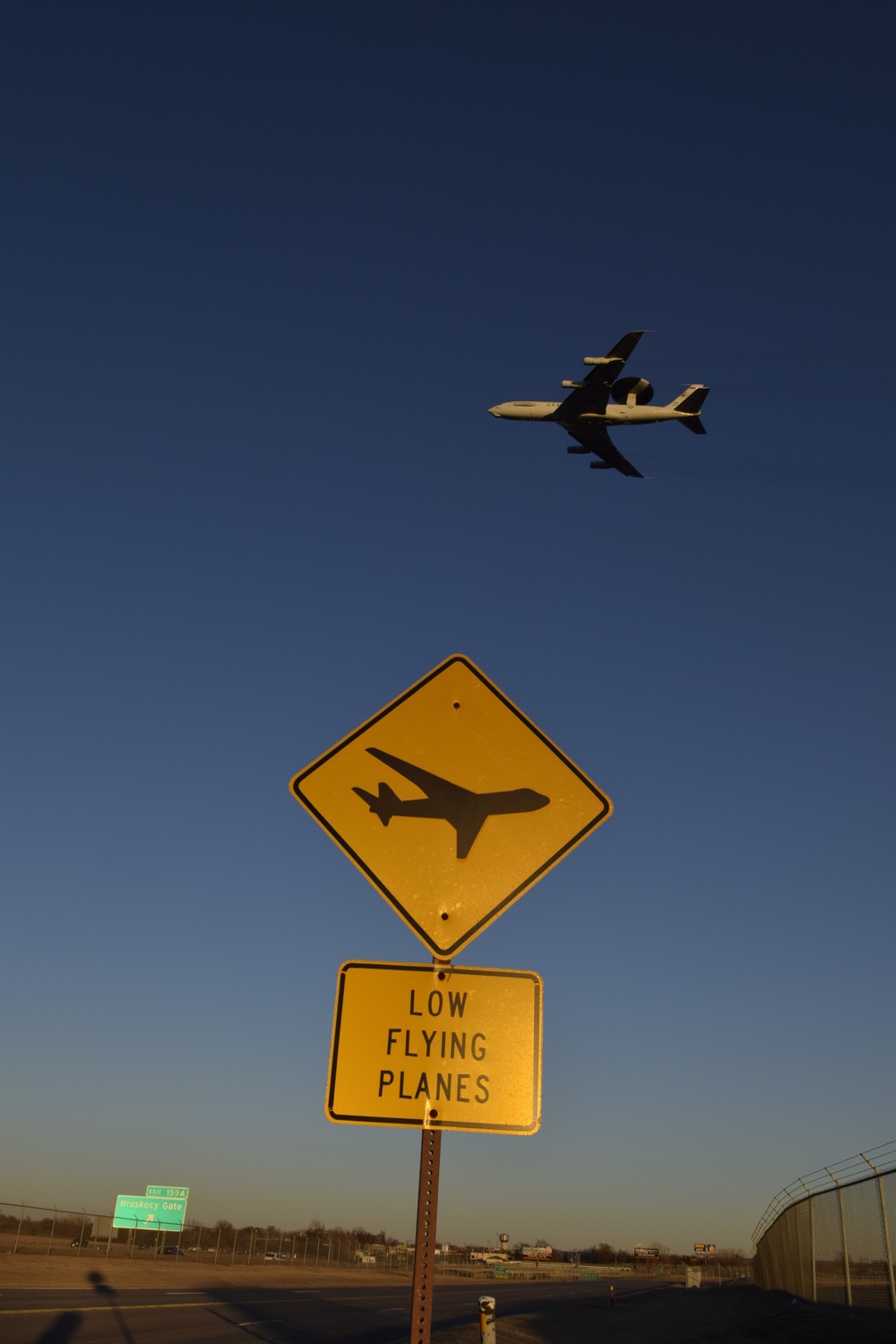 Low-flying planes sign with E-3 overhead