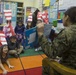 Marines read to children at Zukeren Elementary for Read Across DoDEA Day