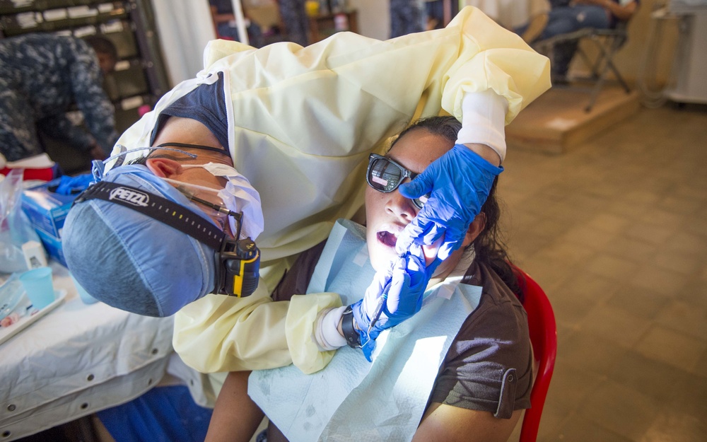 Cmdr. Amy Lynn Bryer performs dental work at the Continuing Promise 2017 (CP-17) medical site