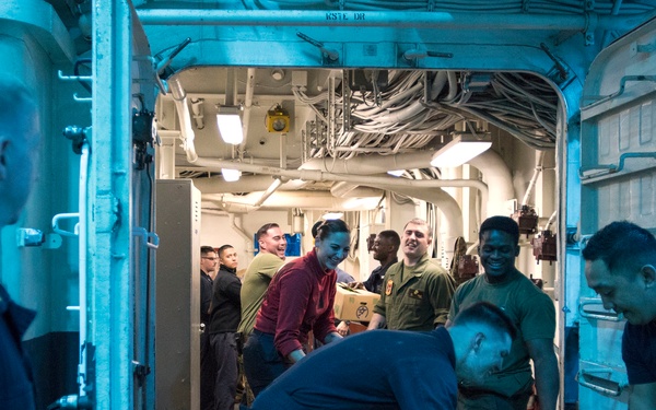 USS Bonhomme Richard (LHD 6) conducts nighttime replenishment at sea