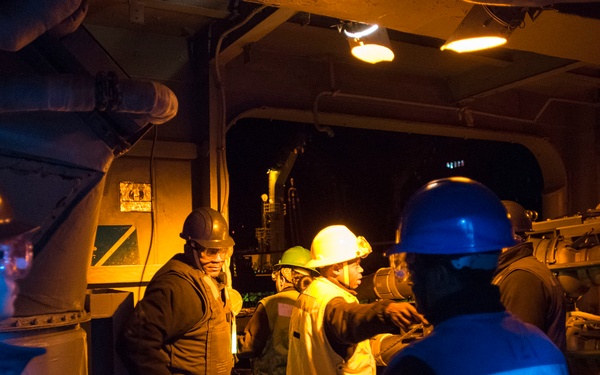 USS Bonhomme Richard (LHD 6) conducts nighttime replenishment at sea