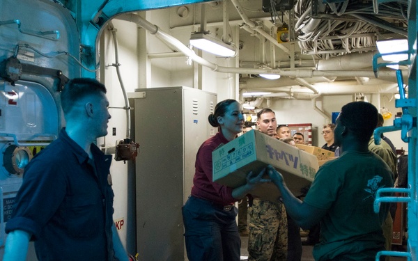 USS Bonhomme Richard (LHD 6) conducts nighttime replenishment at sea