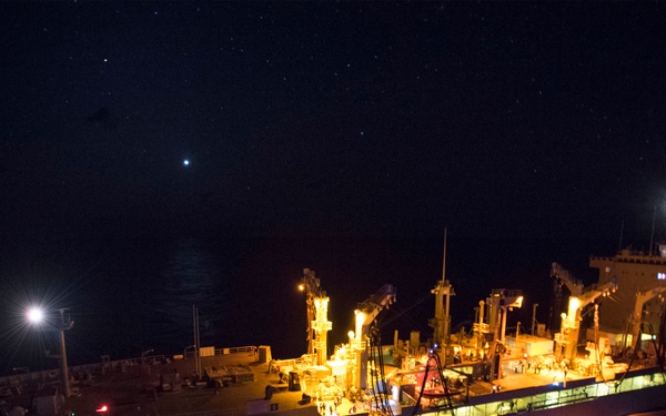 USS Bonhomme Richard (LHD 6) conducts nighttime replenishment at sea