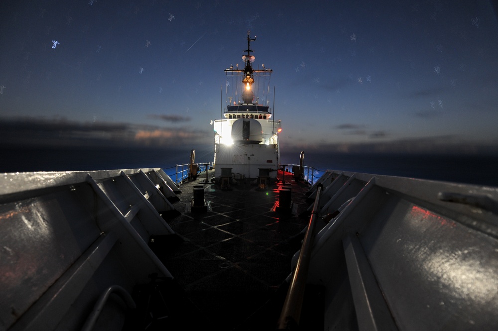 U.S. Coast Guard Cutter Mellon patrols at night during Operation North Pacific Guard