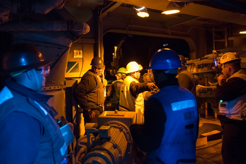 USS Bonhomme Richard (LHD 6) conducts nighttime replenishment at sea