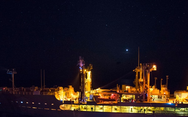 USS Bonhomme Richard (LHD 6) conducts nighttime replenishment at sea