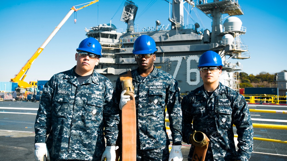 Albert Mendez and Mates Perform Maintenance on a Hose of an Aqueous Film Forming Foam (AFFF) Station