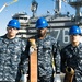 Albert Mendez and Mates Perform Maintenance on a Hose of an Aqueous Film Forming Foam (AFFF) Station