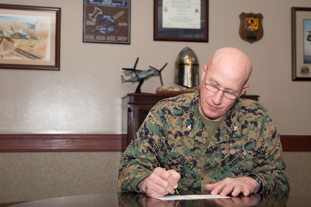 MCAS Iwakuni CO fills out  allotment form for Active Duty Fund Drive