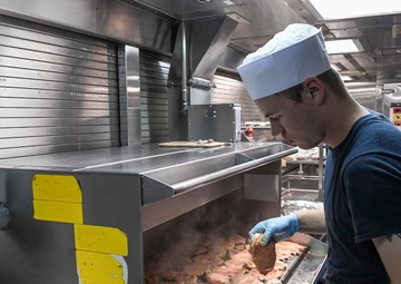 USS Wayne E. Meyer Sailor Prepares Dinner
