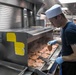 USS Wayne E. Meyer Sailor Prepares Dinner