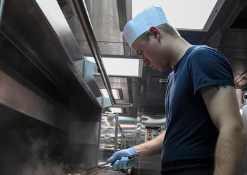 USS Wayne E. Meyer Sailor Prepares Dinner