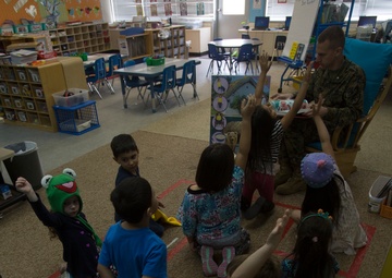 Marines read to children at Zukeren Elementary for Read Across DoDEA Day