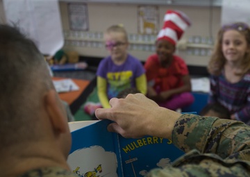 Marines read to children at Zukeren Elementary for Read Across DoDEA Day