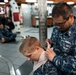 Logistics Specialist applies a pressure dressing to the neck of Operations Specialist Seaman Joshua Hansen