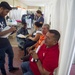 Sailors and Honduran volunteers check in host nation patients
