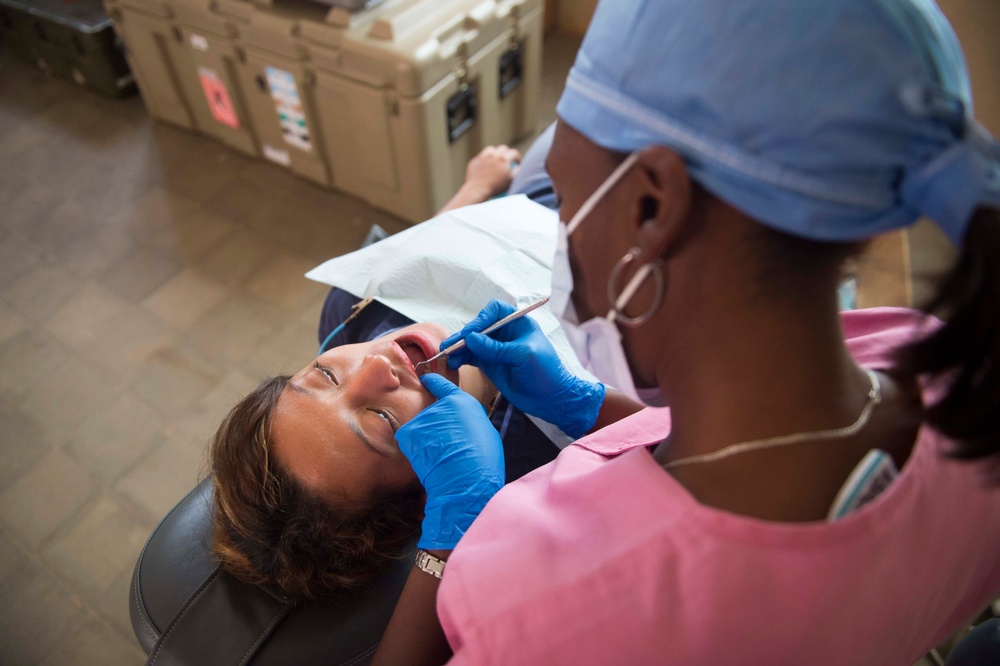 Honduran dentist performs dental work on a host nation patient at Continuing Promis