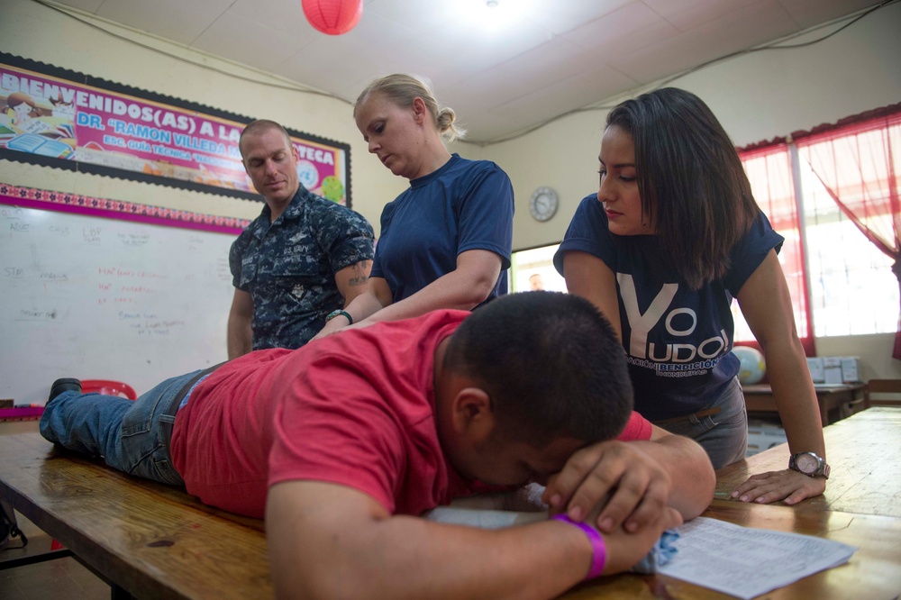 Lt. Lisa Daily performs a physical therapy examination at Continuing Promise 2017