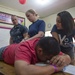 Lt. Lisa Daily performs a physical therapy examination at Continuing Promise 2017