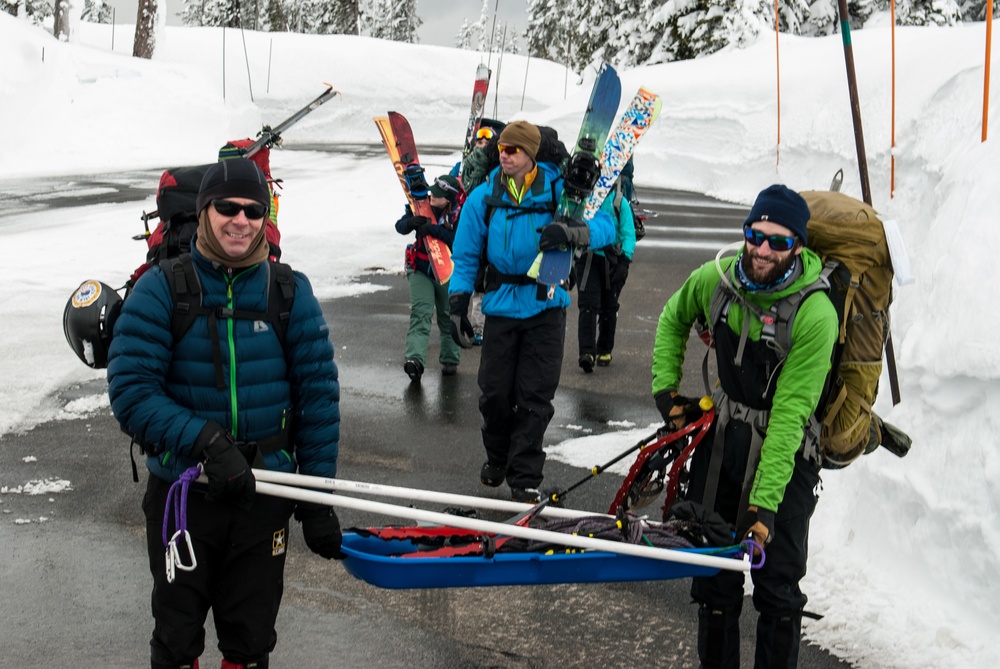 Mark Deschenes, left, and Derrick Pierson, carry a sled loaded with supplies at Mount Rainier National Park, Washington