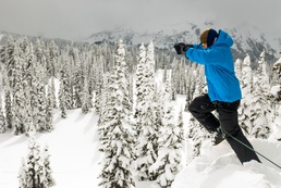 Joseph Byrnes leaps off of a snow bank to simulate falling into a crevasse, at the JBLM Alpine Club basic alpine course, Mount Rainier National Park, Washington
